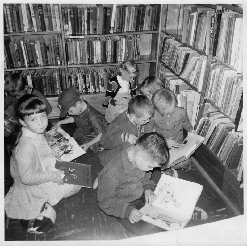 Children reading on the floor of the boys and girls area at Weston Library (1964)