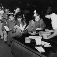 boys and girls house_kids lining up to sign out books.jpg